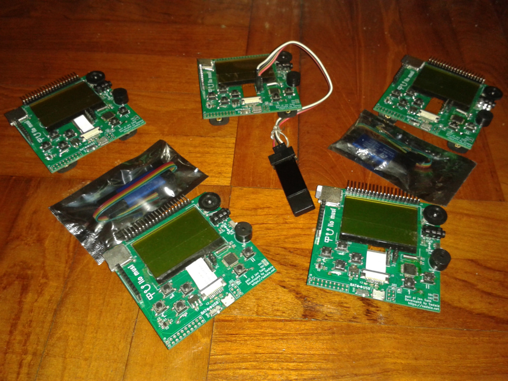 A photo showing 5 game consoles with 3 ST-Link programmers